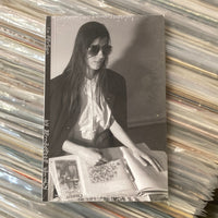 Vintage photo of a woman on a stack of records