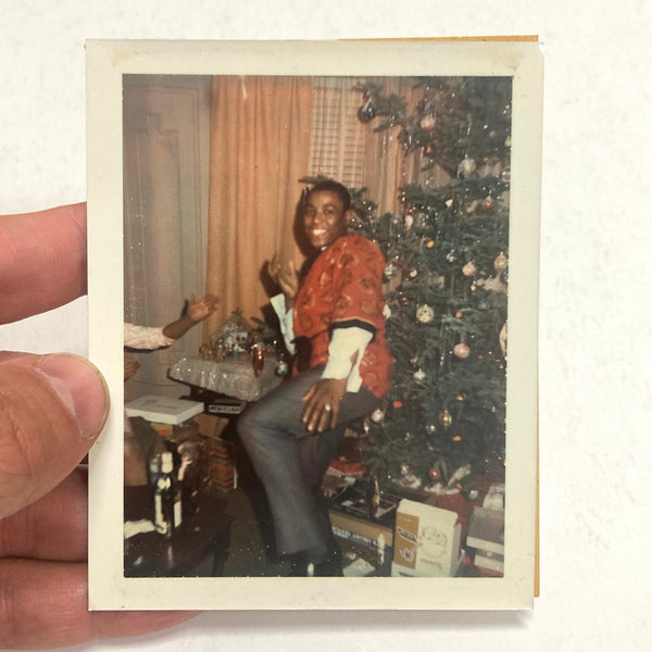 Photograph of Handsome African-American Man Posing by Christmas Tree