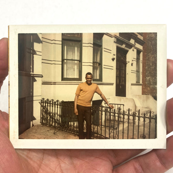 Photograph of African-American Man Posing Next to Building Fence (2)