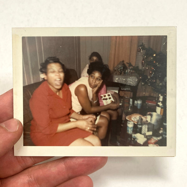 Photograph of African-American Woman in mid-exclamation with onlookers, at Christmas?